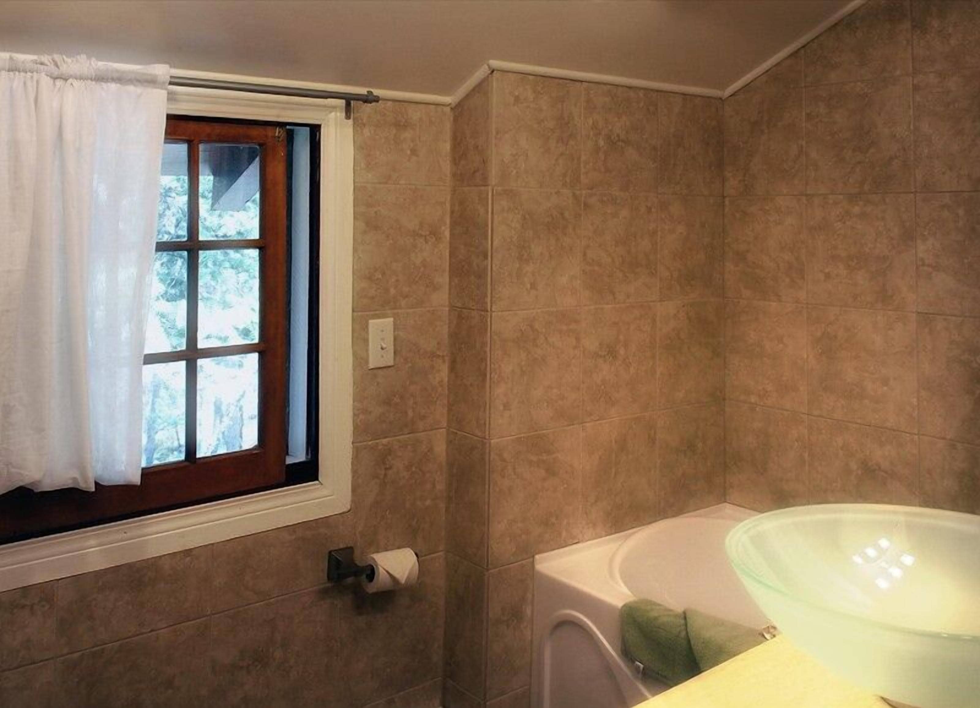 two bedroom cabin | bathroom | combined shower/bathtub, hair dryer, towels
