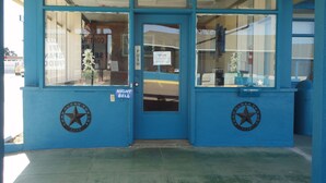A blue building with a glass door, a 'Night Bell' sign, and a 'Push' sign.