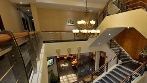 A multi-level hotel lobby with a chandelier, a staircase, and a seating area. - Asiana Hotel (Kota Kinabalu)