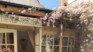 A rustic wooden building with a sign reading "THE OLD WORKSHOP."