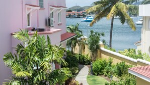 A coastal building with a balcony overlooking a marina. - The Harbour (Gros Islet)