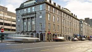 A historic building with multiple floors, large windows, and a prominent entrance. - Royal Athenaeum Suites (Aberdeen)