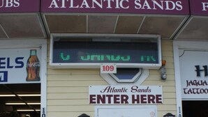 A building with a sign reading "Atlantic Sands ENTER HERE" and a digital display above it. - Atlantic Sands (Hampton)