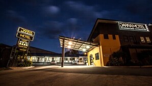 A Darramotel with a covered entrance, a signboard indicating a truck parking area, and a visible building facade. - Darra Motel and Conference Centre (Darra)
