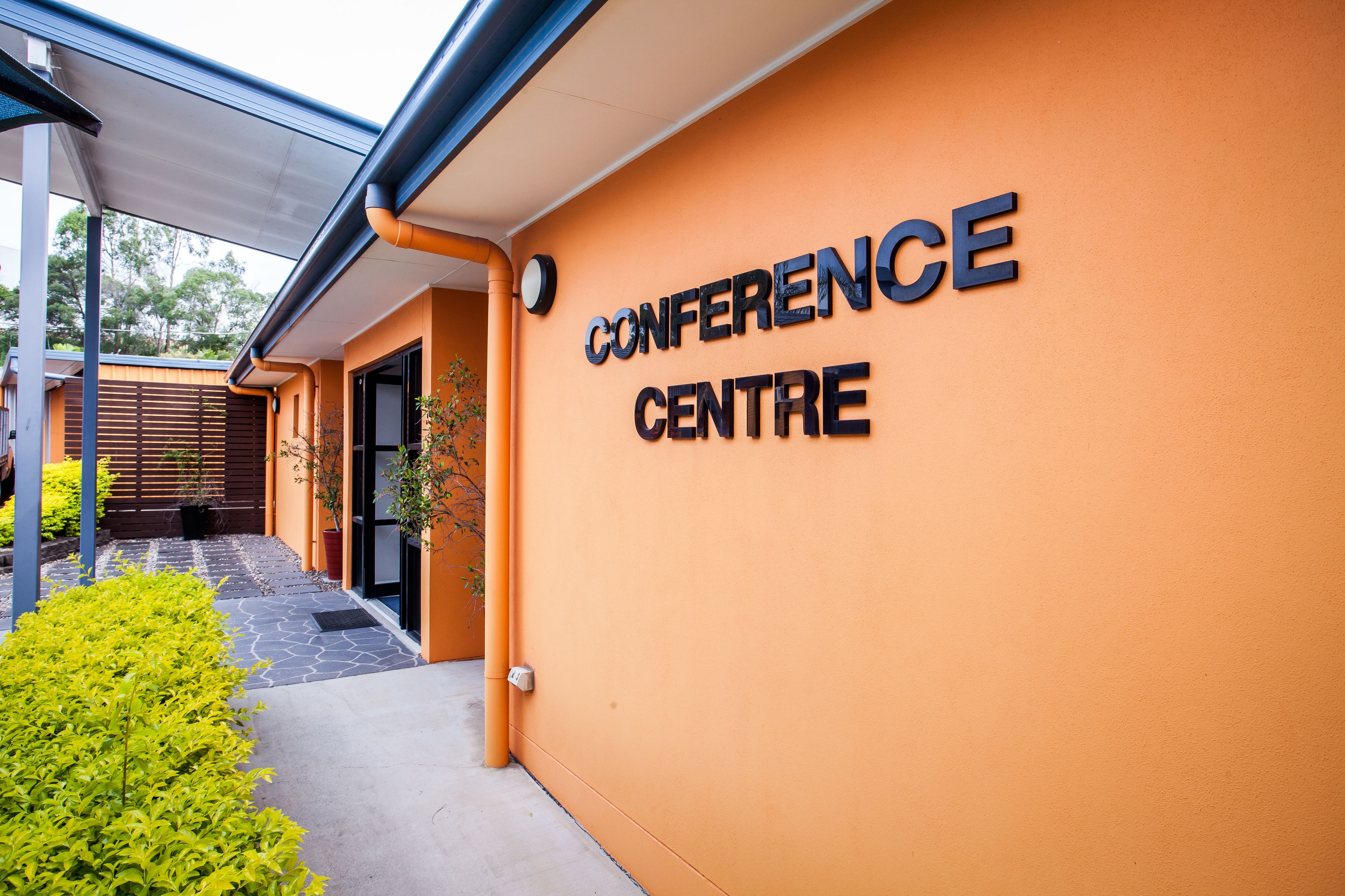 The exterior of a building with a sign reading "CONFERENCE CENTRE".