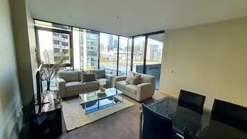 Appartamento Deluxe, 2 camere da letto, 2 bagni, vista porticciolo | Area soggiorno | TV a schermo piatto 50 pollici con canali digitali, TV