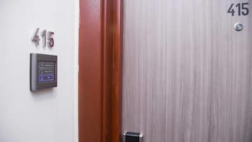 A door with the number 415, a keypad lock, and a peephole.