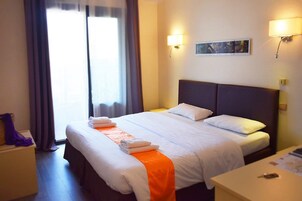 Premium bedding, desk, laptop workspace, iron/ironing board