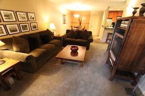 Relax in this inviting living room with a comfortable sofa, coffee table, and lamp.