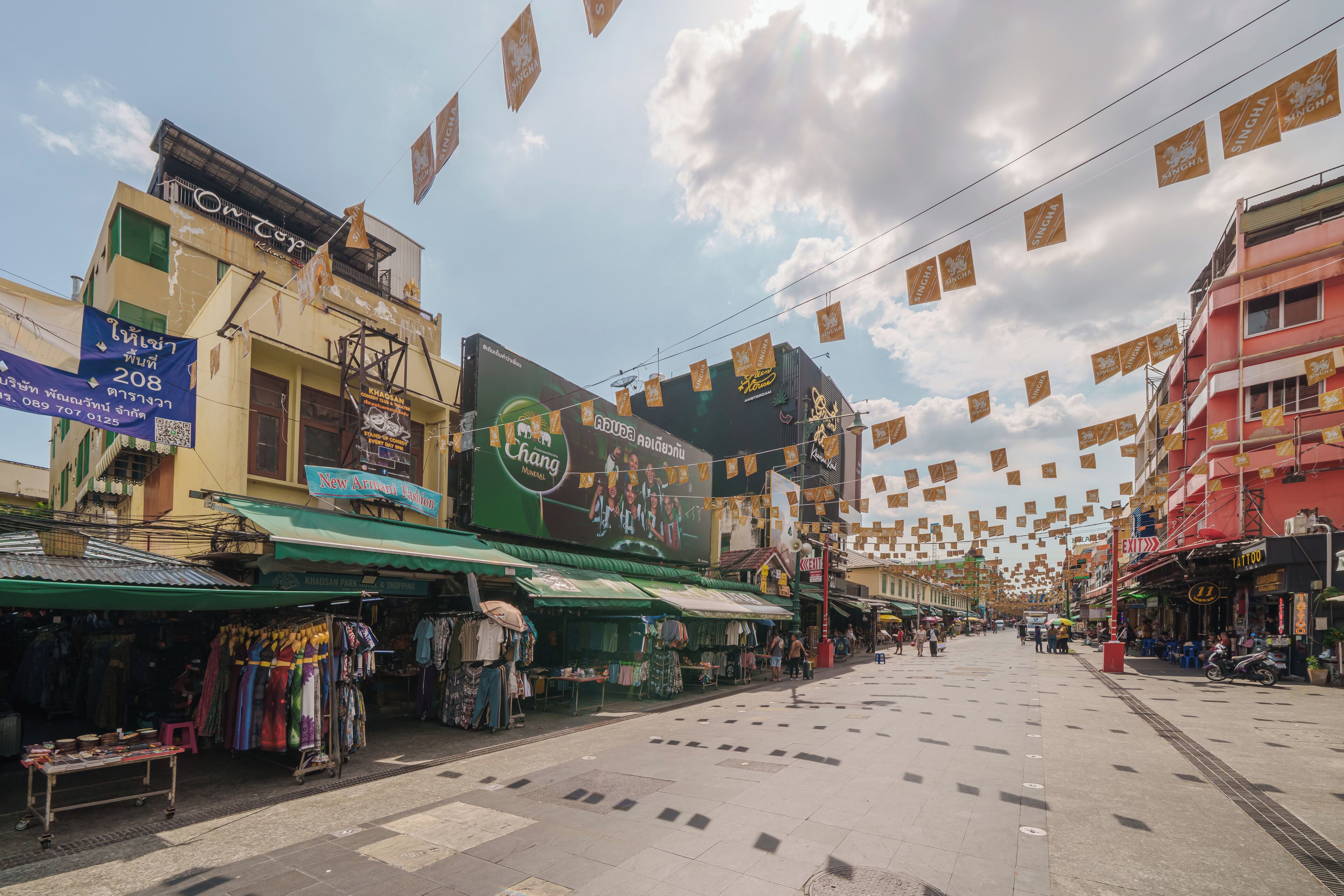 A street with shops and a large billboard.