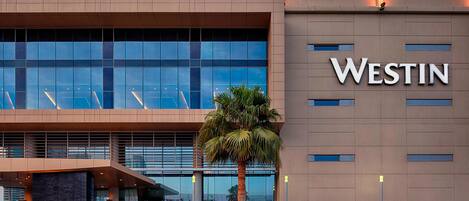 A modern building with a large glass facade and the name "WESTIN" prominently displayed.