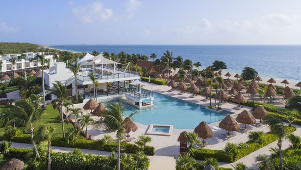 A resort with a pool, beach umbrellas, and a view of the ocean. - Finest Playa Mujeres by The Excellence Collection - All Inclusive (Punta Sam)