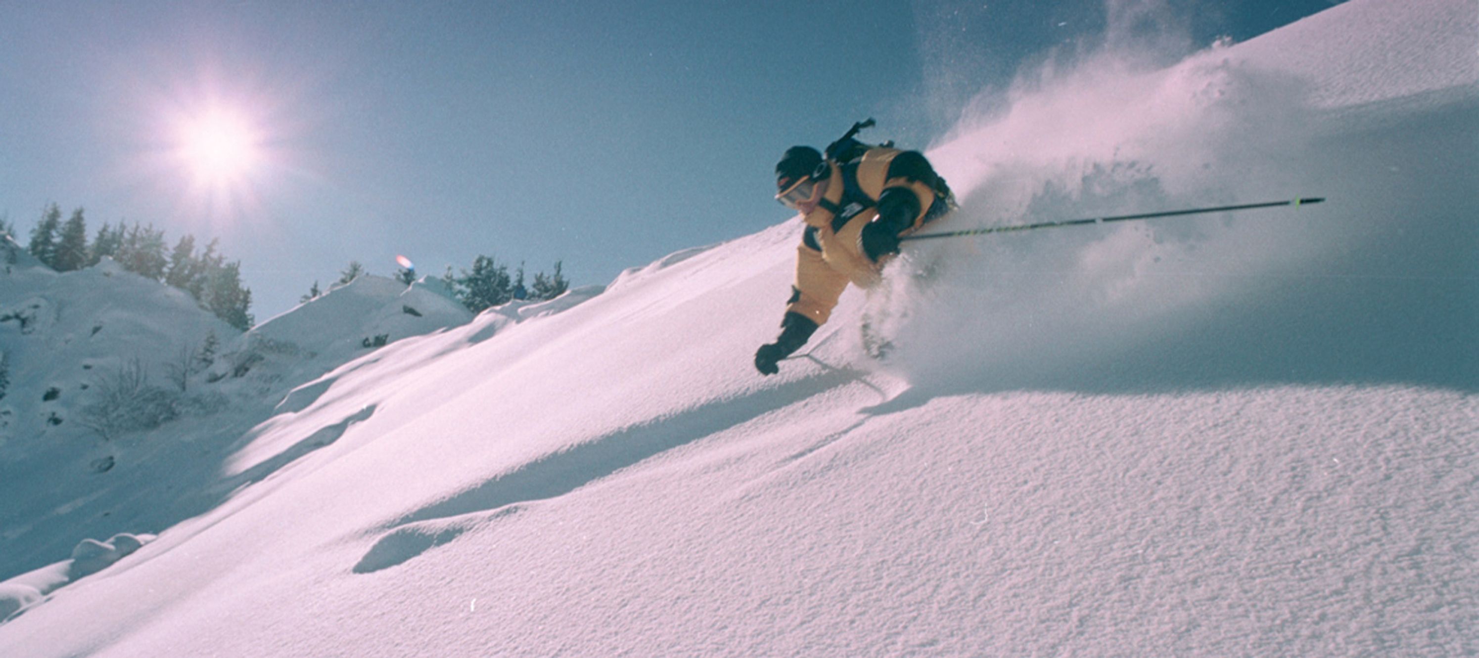 A person skiing down a snowy slope.