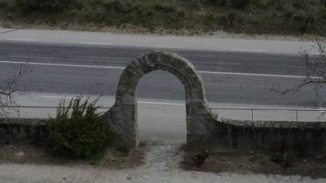 A stone archway leading to a road.