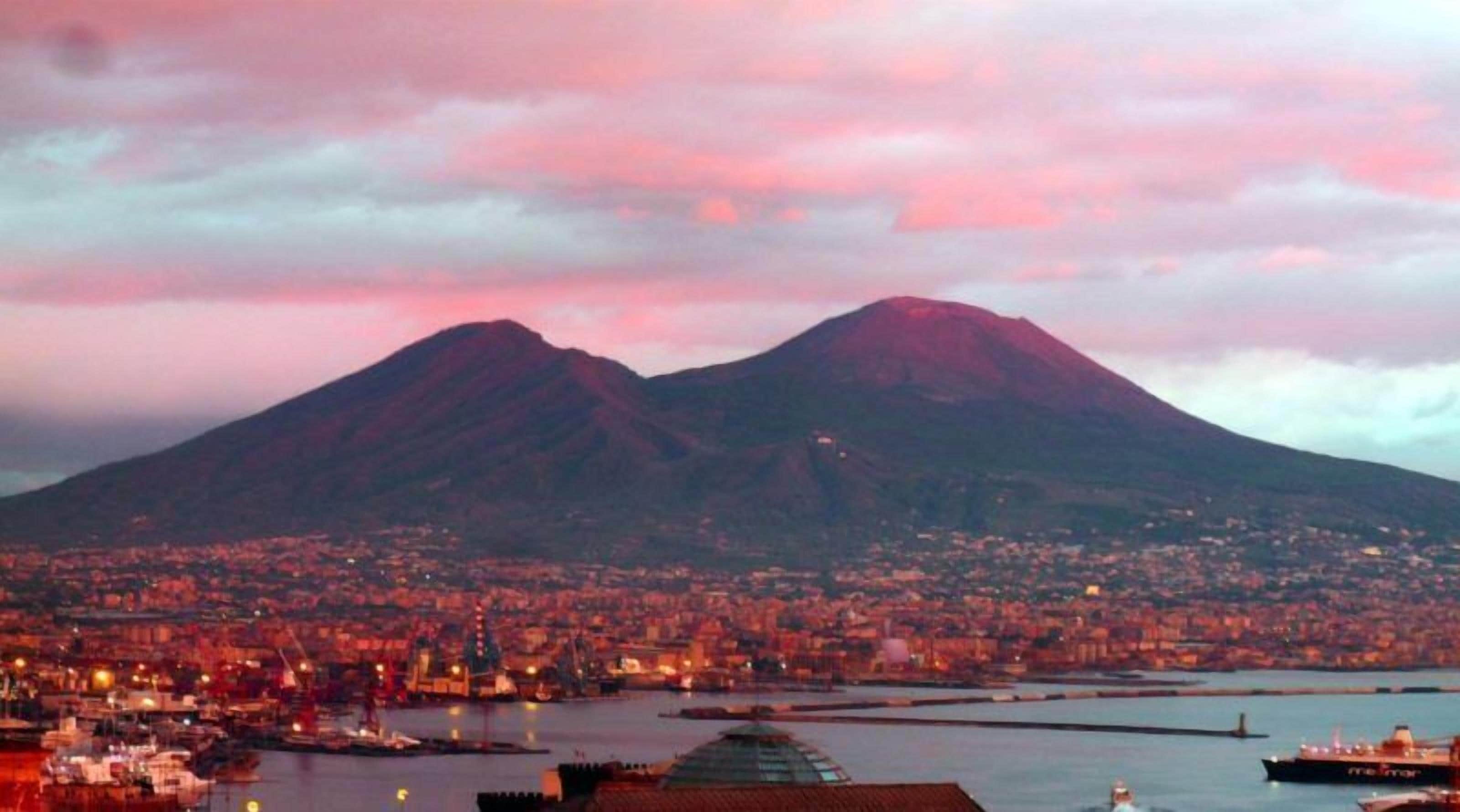 A cityscape with a prominent mountain in the background.