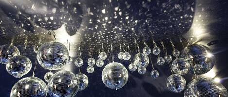 A series of disco balls suspended from the ceiling.