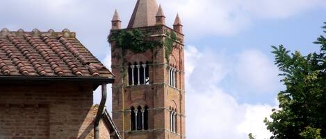 A church with a tall bell tower and a brick facade.