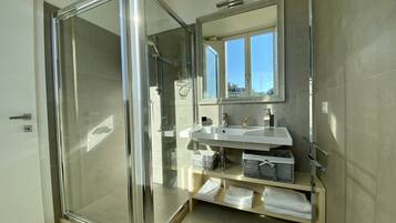Junior Suite, City View | Bathroom | Shower, eco-friendly toiletries, hair dryer, bathrobes