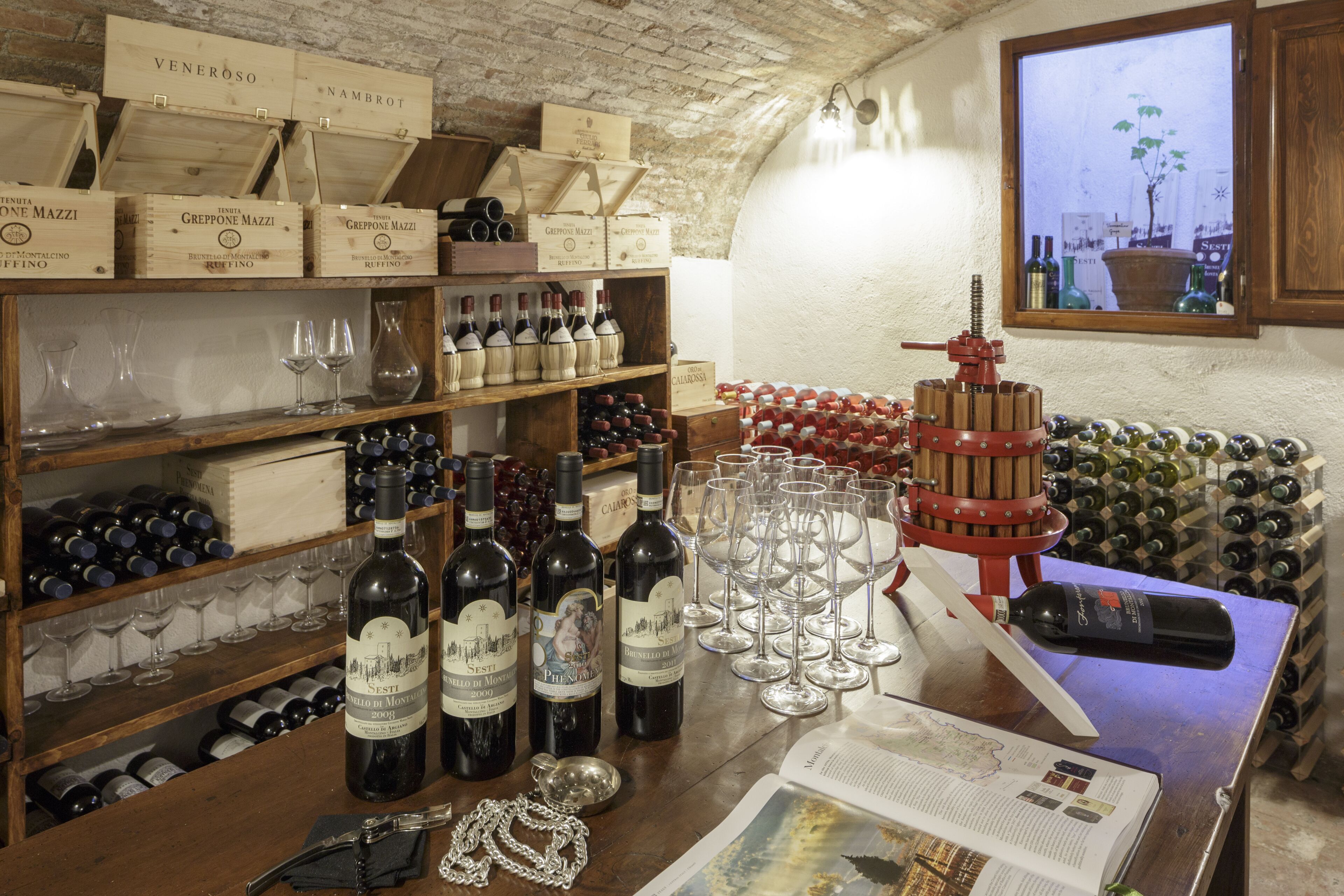 A wine cellar with wooden shelves, wine bottles, and glasses.