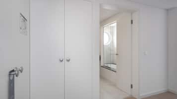 Un bagno moderno e minimalista con cabina doccia in vetro e mobile lavabo bianco.