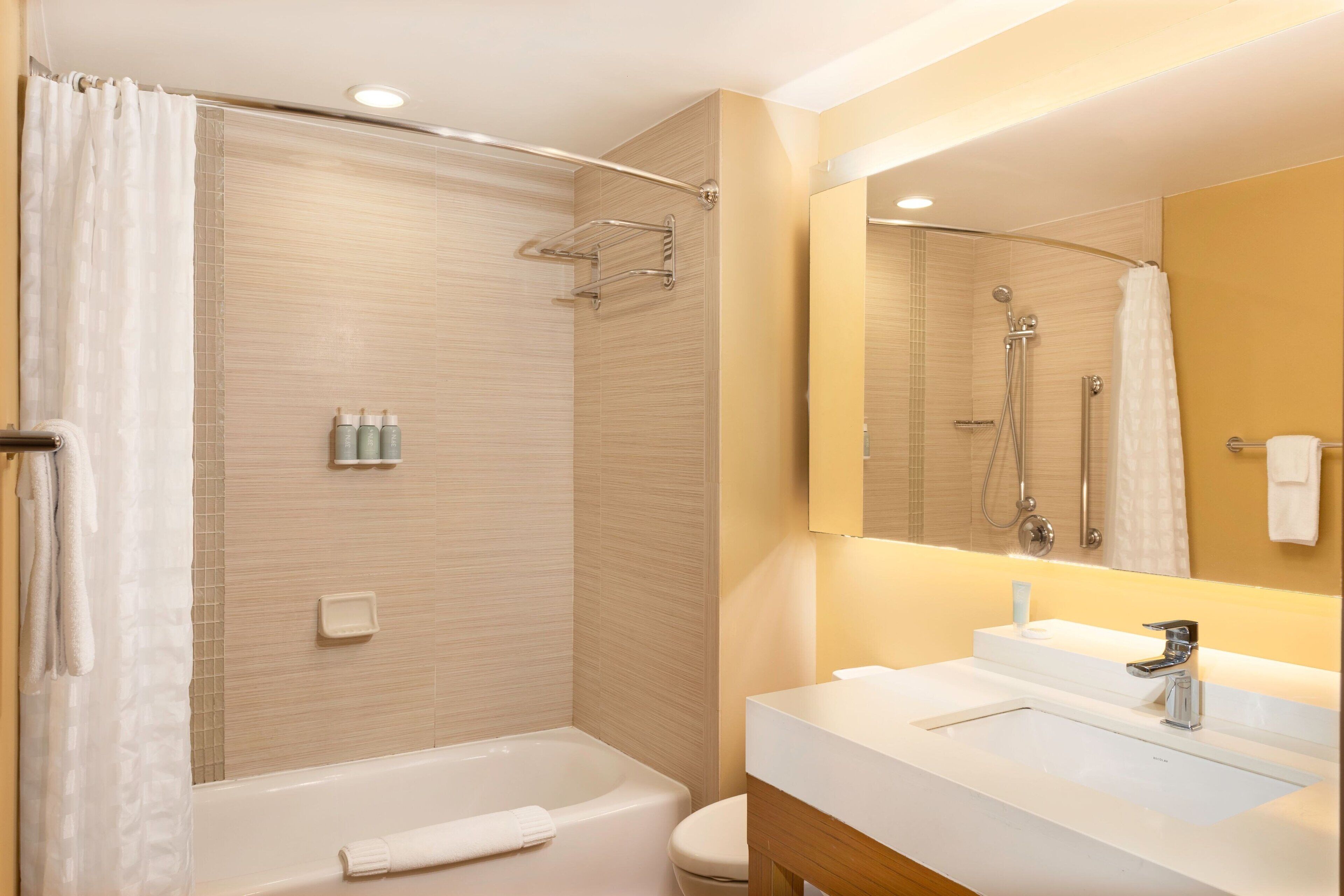 hydromassage showerhead, designer toiletries, hair dryer, towels