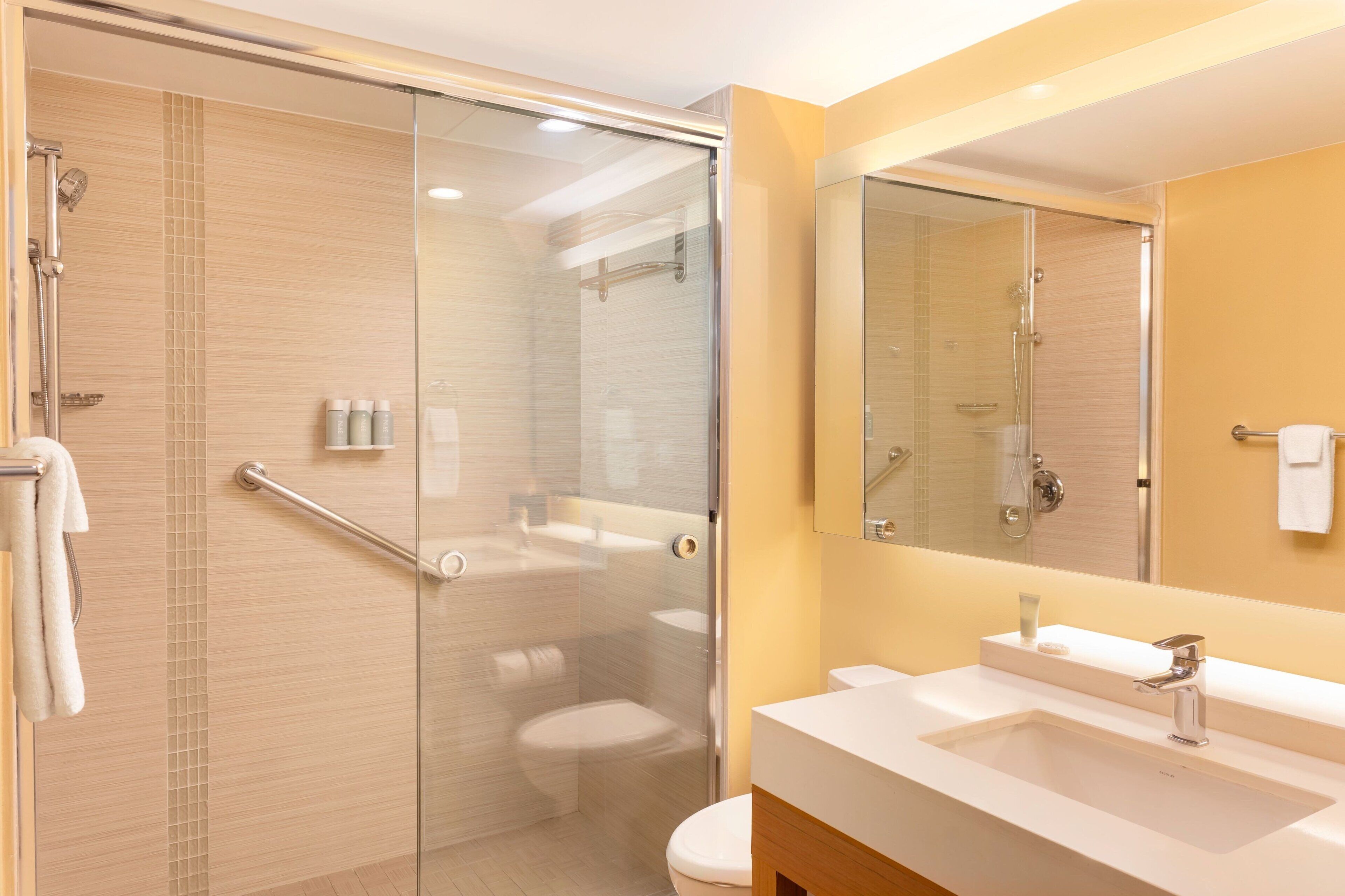 hydromassage showerhead, designer toiletries, hair dryer, towels