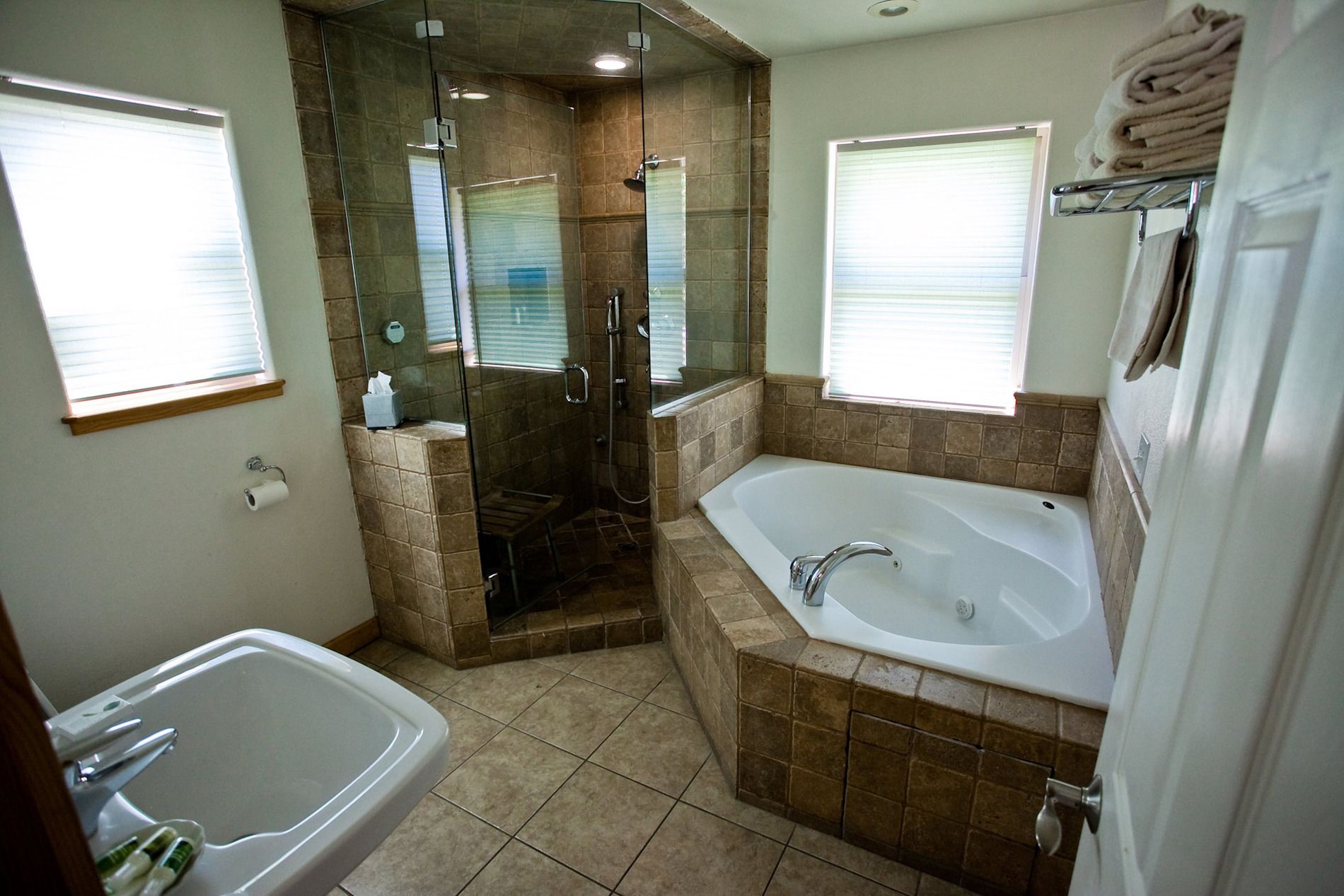 A bathroom with a walk-in shower, a bathtub, and a toilet.