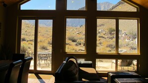 A room with large windows offering views of a mountainous landscape. - Convict Lake Resort (Mammoth Lakes)