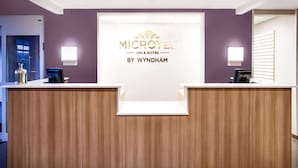 A reception desk with a sign reading "MICROTEL INN & SUITES BY WYNDHAM".