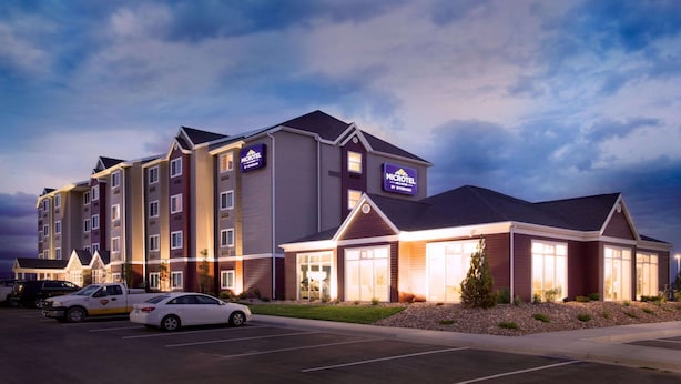 A multi-story hotel with a prominent sign for the Wyndham Microtel brand.