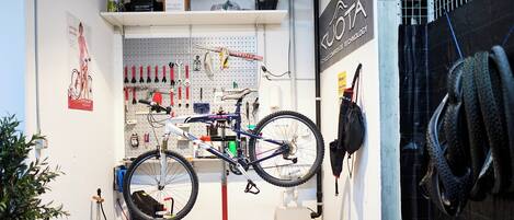 A bicycle repair station with tools and a bike on a stand.