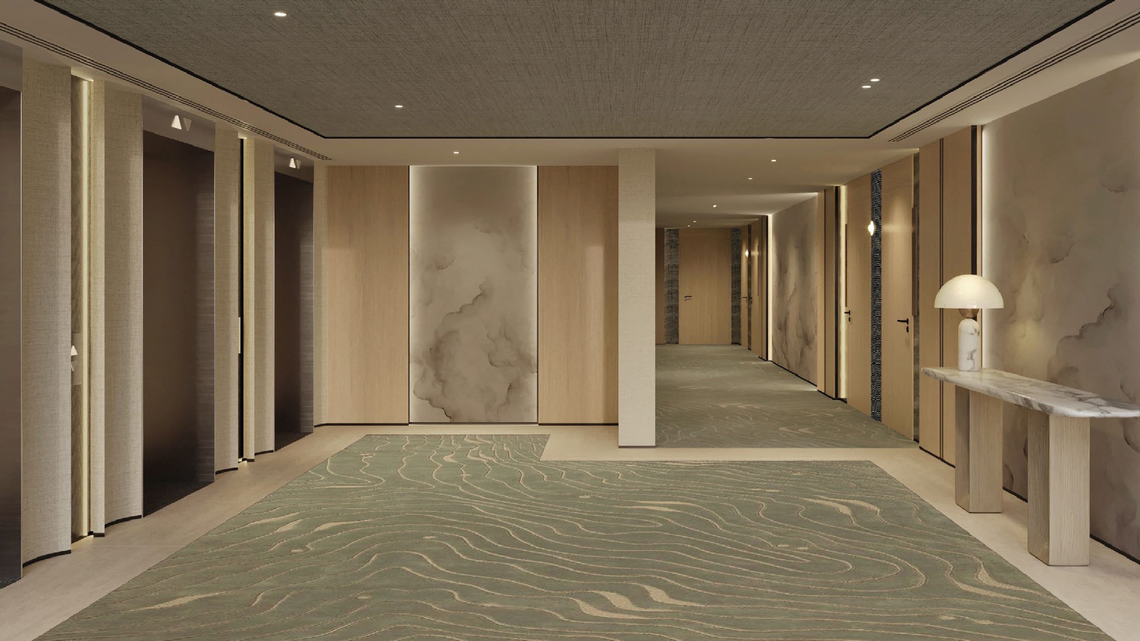 A hotel hallway with a patterned carpet, wooden panel walls, and a marble-topped console table.