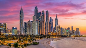 A city skyline with high-rise buildings, a beach, and palm trees. - InterContinental Dubai Marina by IHG (Dubai)