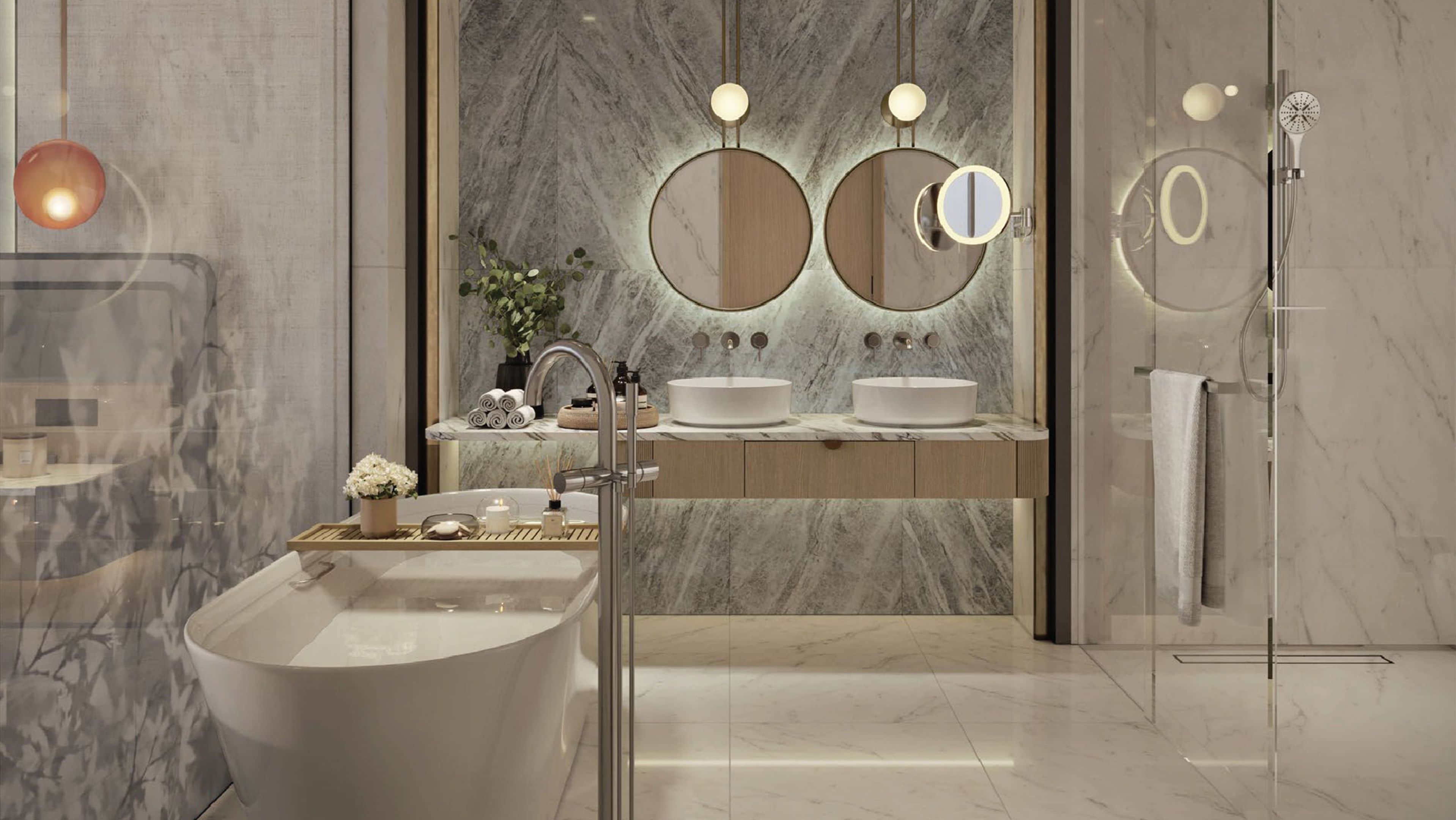 A modern bathroom with a freestanding bathtub, two sinks, and a shower.