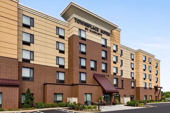A multi-story hotel with a brick facade and a flat roof.