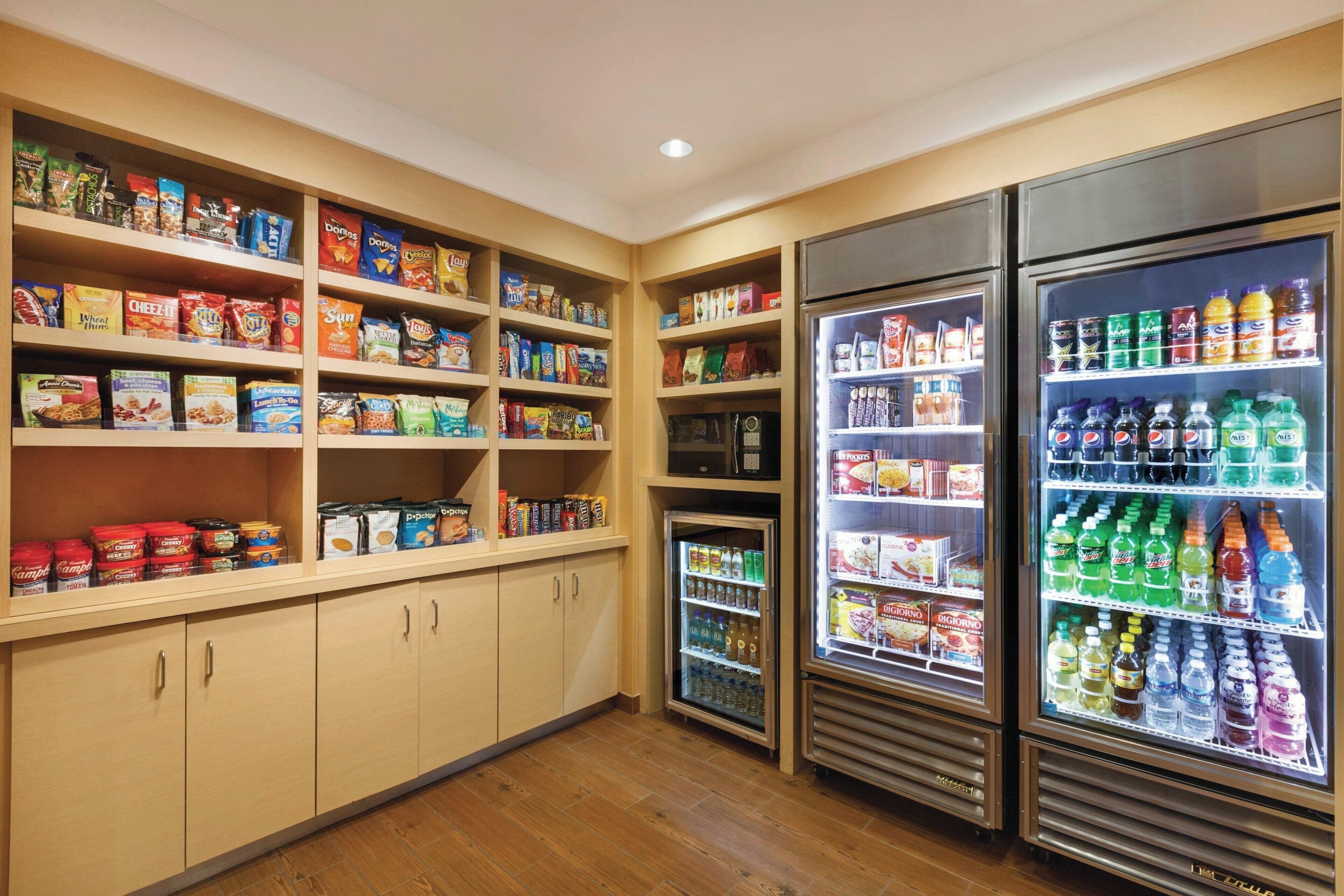 A well-stocked pantry with shelves of snacks, canned goods, and beverages.