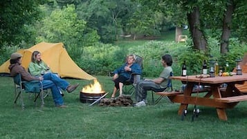Guests can enjoy a campfire gathering in a serene natural setting.