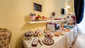 A buffet table with various food items and a chalkboard sign. - La Reggia dei Principi (Rome)