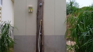 A wooden door with a metal handle and a small bell. - Phuket7-inn Hotel (Chalong)