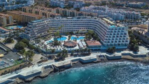 A large resort with multiple swimming pools, a beachfront, and a mountainous backdrop. - Spring Arona Gran Hotel & SPA - Adults Only (Arona)