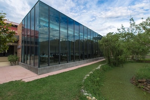 A modern building with large glass windows and a brick facade.