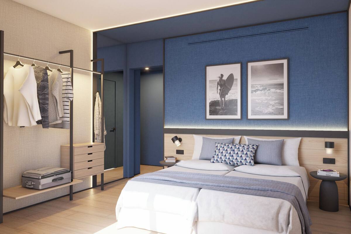 Une chambre moderne avec un grand lit, des tables de chevet, une armoire et un miroir.
