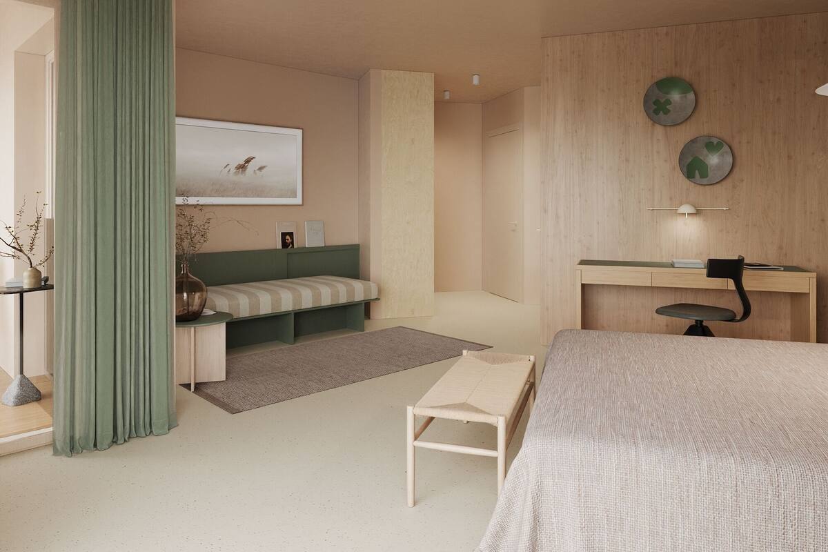A modern bedroom with a bed, a desk, a chair, a ceiling fan, and a wall-mounted TV.