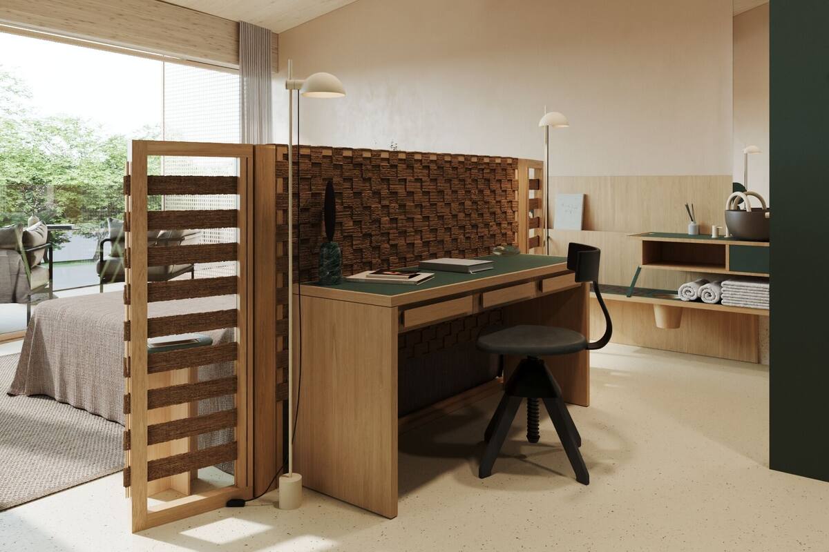 A modern, minimalist office space with a wooden desk, a chair, and a partition with a brick pattern.