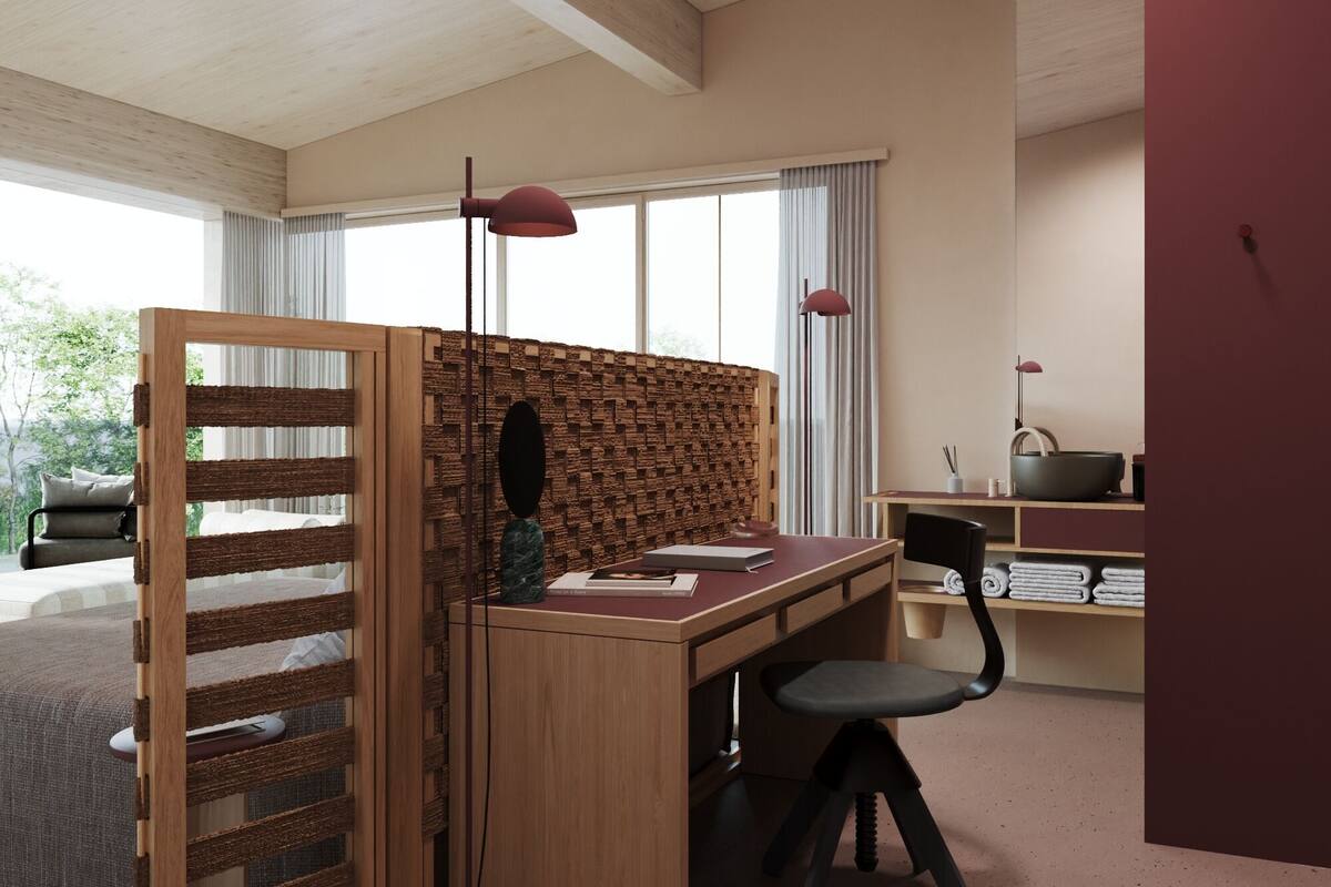 A modern office space with a wooden desk, a chair, a bookshelf, and a partition with a woven design.