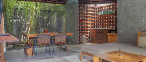 A modern interior with a dining area, a sofa, and a coffee table.