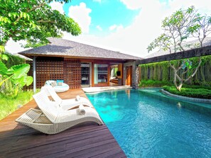 A modern house with a pool, wooden deck, and outdoor seating. - The Santai by LifestyleRetreats (Kerobokan)