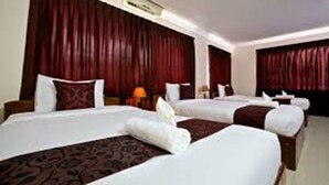 A hotel room with two beds, red curtains, and a nightstand with a lamp. - Angkor Vattanak Pheap Hotel (Siem Reap)