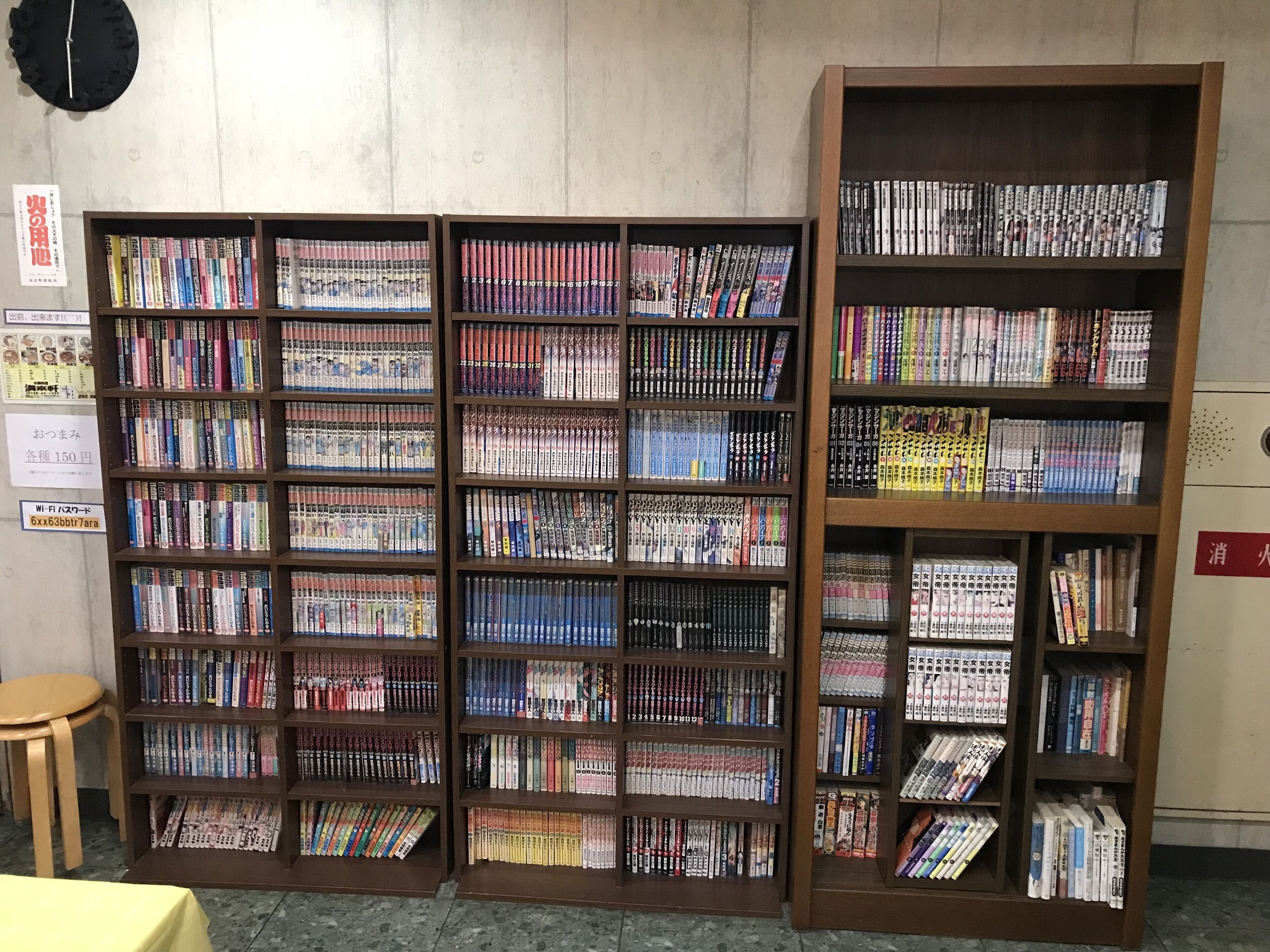 A library with multiple wooden bookshelves filled with books.