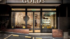 The exterior of the Gold3 Boutique Hotel with large glass windows and a brick facade. - Gold3 Boutique Hotel (Kuala Lumpur)